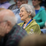 smiling woman attending a lecture