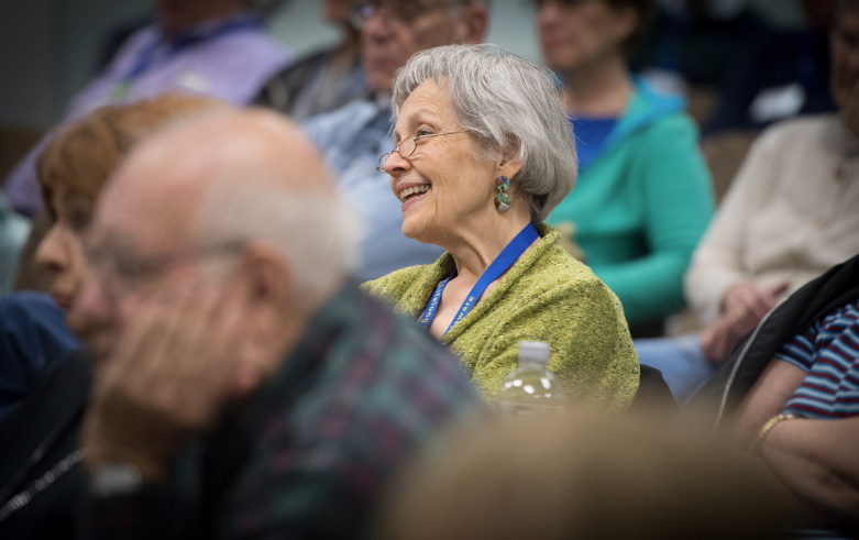 smiling woman attending a lecture